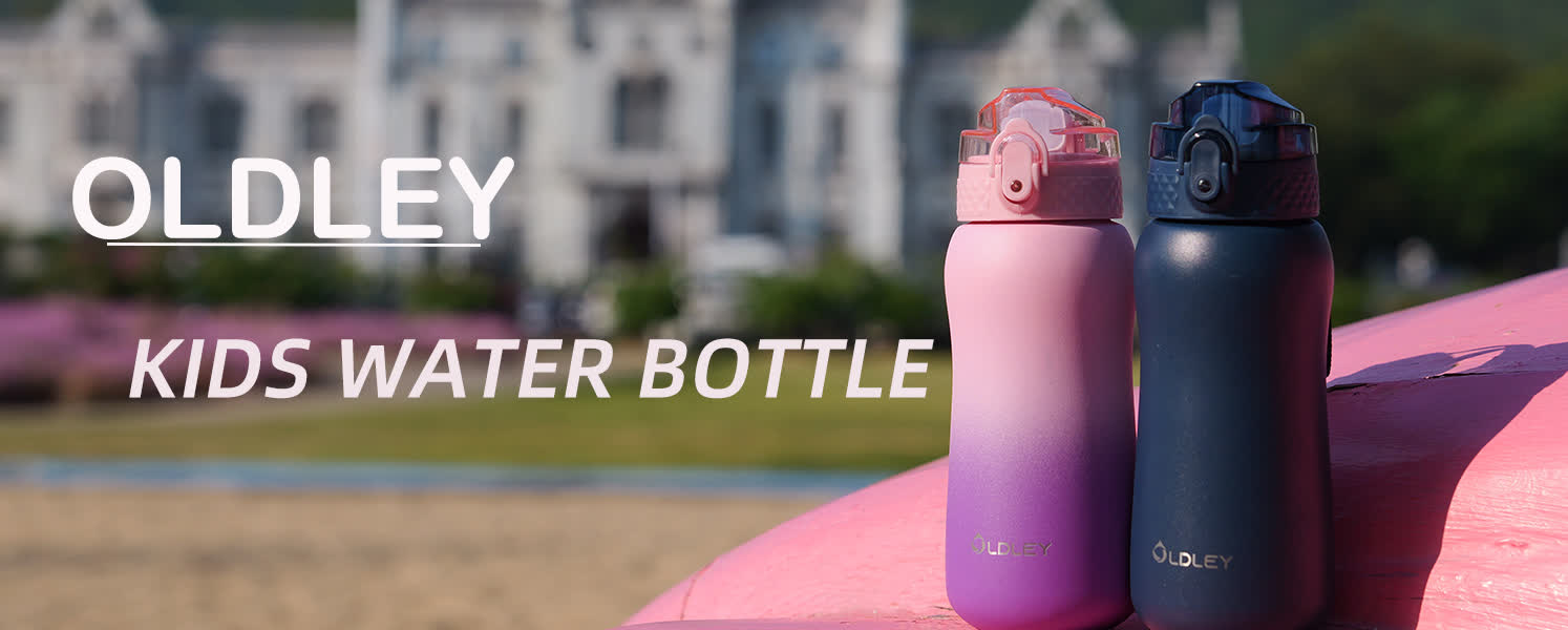 two water bottles pink and blue sitting on pink ledge with blurred building background