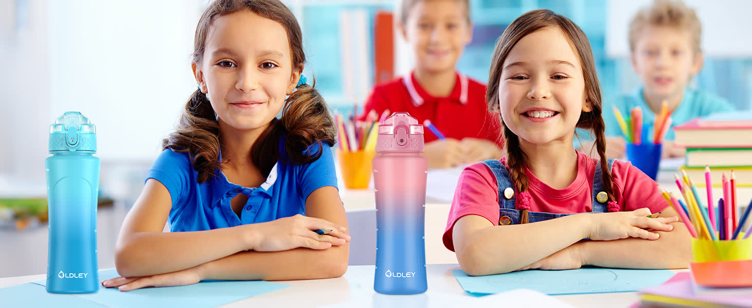 two girls sitting at school desk with blue and pink gradient water bottles and colorful pencils in background